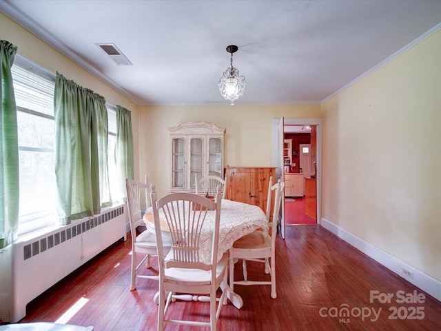 1614 Linwood Rd, Gaston, NC 28052 - dining space featuring radiator, ornamental molding, wood finished floors, baseboards, and a chandelier