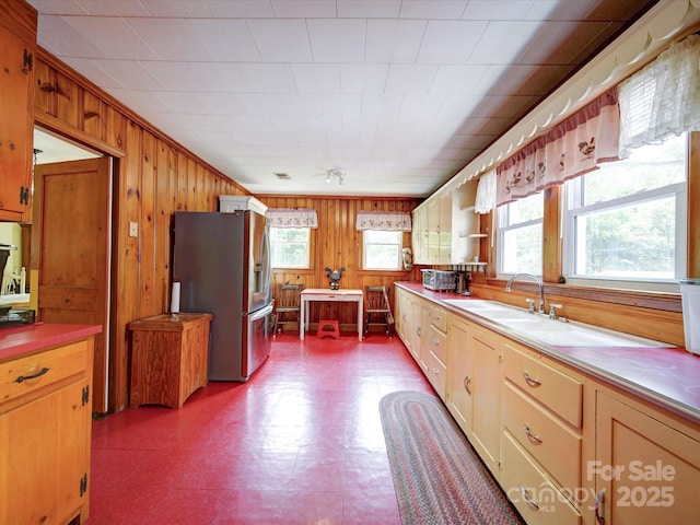 1614 Linwood Rd, Gaston, NC 28052 - kitchen with stainless steel fridge, wood walls, dark floors, light countertops, and open shelves