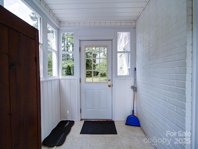 1614 Linwood Rd, Gaston, NC 28052 - doorway featuring brick wall, plenty of natural light, and light tile patterned floors