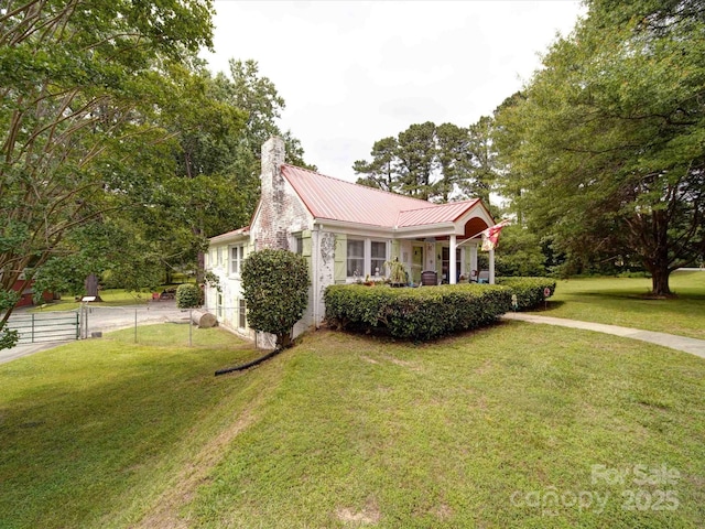 1614 Linwood Rd, Gaston, NC 28052 - view of front of house with a chimney, metal roof, and a porch