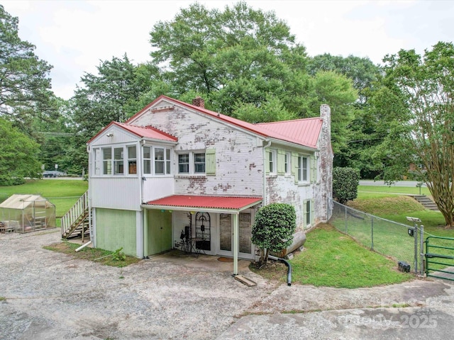 1614 Linwood Rd, Gaston, NC 28052 - view of front of home with an exterior structure, a chimney, metal roof, a gate, and an outdoor structure