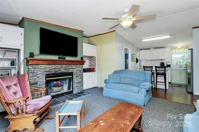 4104 Pebblebrook Cir SW, Concord, NC 28027 - living area featuring crown molding, a ceiling fan, a fireplace, vaulted ceiling, and a textured ceiling