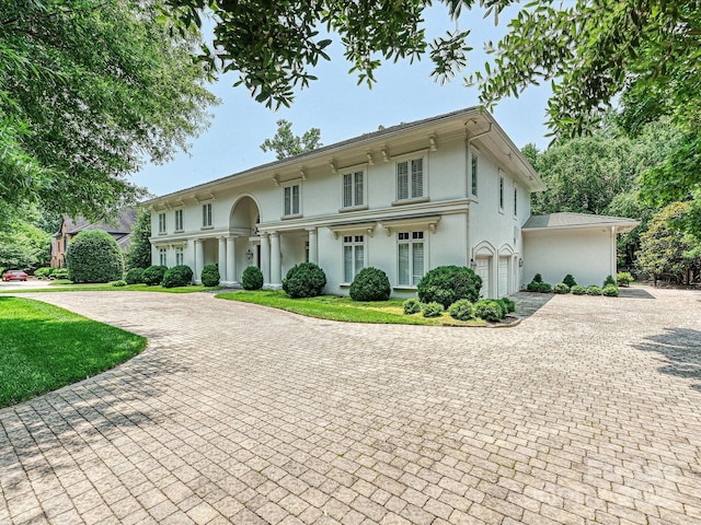 4300 Cameron Oaks Dr, Charlotte, NC 28211 - view of front facade featuring curved driveway, stucco siding, a garage, and a front lawn