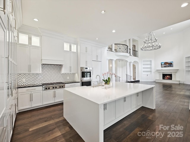 4300 Cameron Oaks Dr, Charlotte, NC 28211 - kitchen with stainless steel appliances, a chandelier, white cabinetry, a large island, and recessed lighting