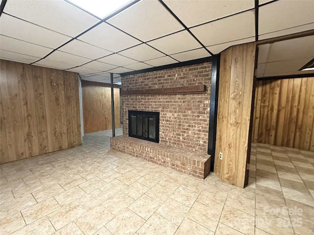 178 Cedar Valley Rd, Hudson, NC 28638 - finished basement with a drop ceiling, wood walls, and a fireplace