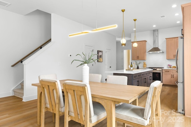 2413 Pruitt St, Charlotte, NC 28208 - dining room featuring light wood-type flooring, stairs, and recessed lighting