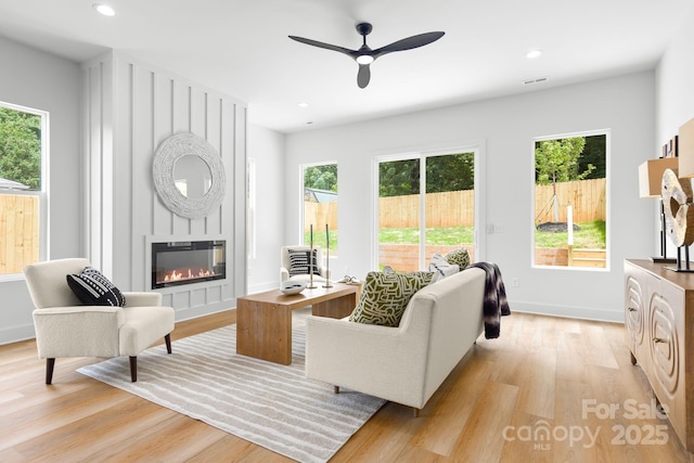 2413 Pruitt St, Charlotte, NC 28208 - living room with light wood-style floors, a fireplace, ceiling fan, and recessed lighting