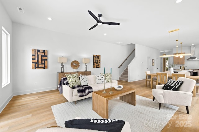 2413 Pruitt St, Charlotte, NC 28208 - living room featuring stairs, healthy amount of natural light, ceiling fan, light wood-type flooring, and recessed lighting