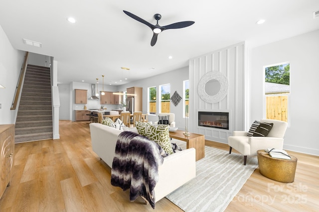 2413 Pruitt St, Charlotte, NC 28208 - living area with a ceiling fan, light wood-type flooring, stairs, a large fireplace, and recessed lighting