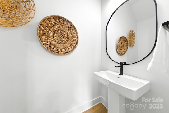 2413 Pruitt St, Charlotte, NC 28208 - bathroom with baseboards and wood finished floors