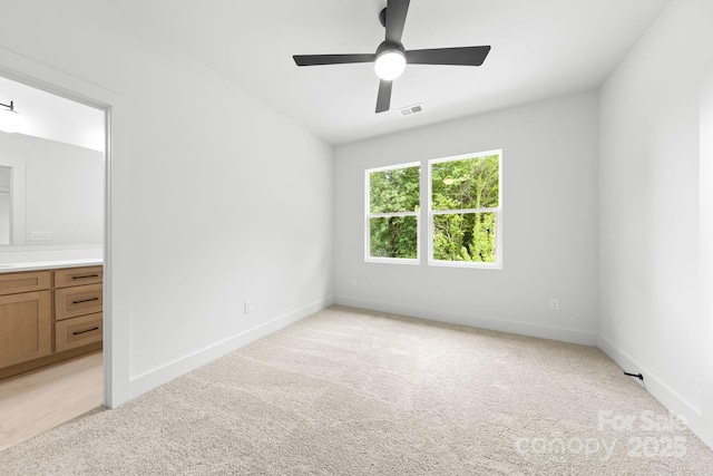 2413 Pruitt St, Charlotte, NC 28208 - unfurnished bedroom with light colored carpet, ensuite bath, and ceiling fan