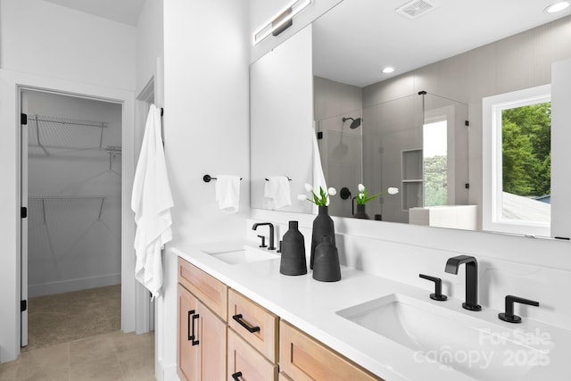 2413 Pruitt St, Charlotte, NC 28208 - full bath with a shower stall, a walk in closet, double vanity, recessed lighting, and tile patterned floors