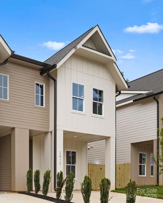 2413 Pruitt St, Charlotte, NC 28208 - view of front facade with board and batten siding and a shingled roof