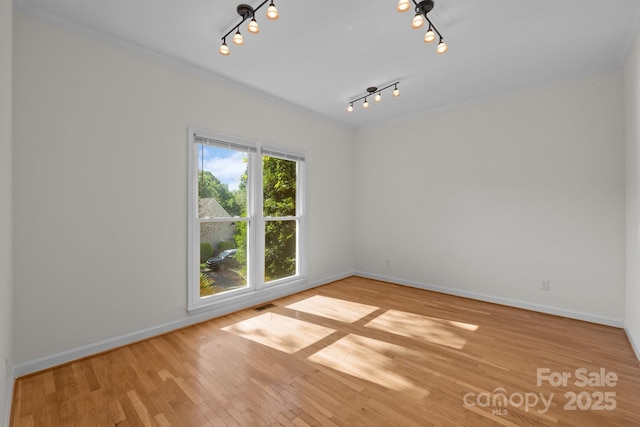 765 Portpatrick Pl, Fort Mill, SC 29708 - unfurnished room with track lighting, wood finished floors, baseboards, and crown molding