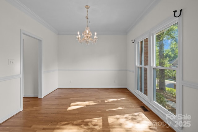 765 Portpatrick Pl, Fort Mill, SC 29708 - unfurnished dining area featuring a chandelier, ornamental molding, wood finished floors, and baseboards