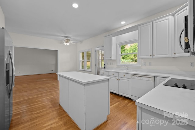 765 Portpatrick Pl, Fort Mill, SC 29708 - kitchen featuring appliances with stainless steel finishes, a center island, ceiling fan, white cabinetry, and a sink