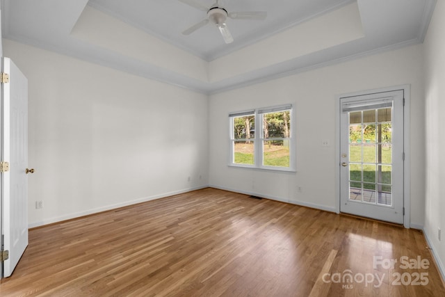 765 Portpatrick Pl, Fort Mill, SC 29708 - empty room featuring a raised ceiling, wood finished floors, a ceiling fan, baseboards, and ornamental molding