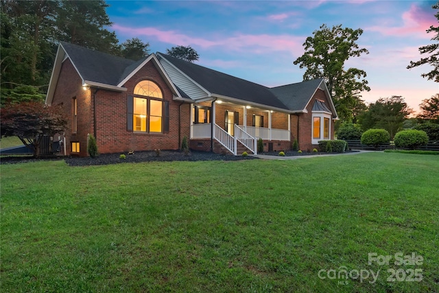 5916 Cashion Rd, Huntersville, NC 28078 - ranch-style home featuring brick siding, a porch, and a yard