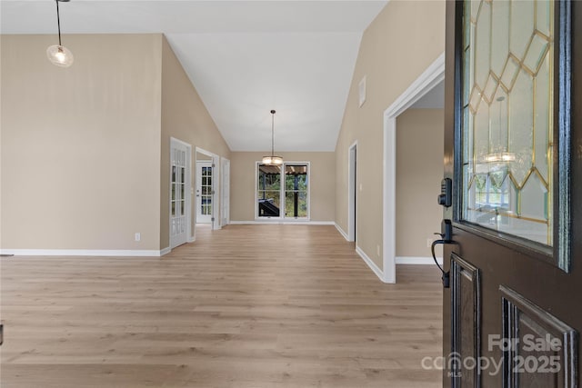5916 Cashion Rd, Huntersville, NC 28078 - foyer entrance with light wood finished floors, high vaulted ceiling, and baseboards