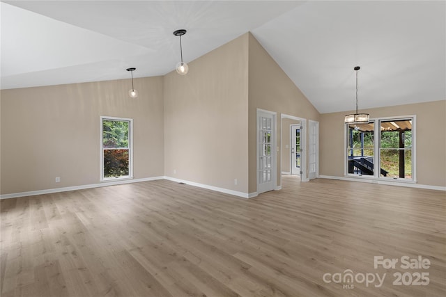 5916 Cashion Rd, Huntersville, NC 28078 - unfurnished living room with high vaulted ceiling, healthy amount of natural light, light wood-style flooring, and baseboards