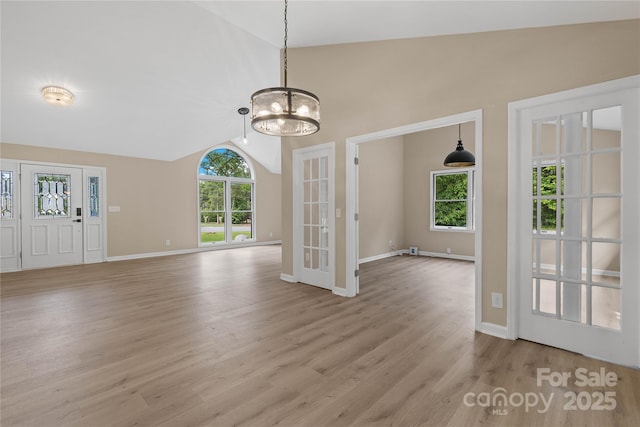 5916 Cashion Rd, Huntersville, NC 28078 - unfurnished dining area featuring vaulted ceiling, light wood-style flooring, a chandelier, and baseboards