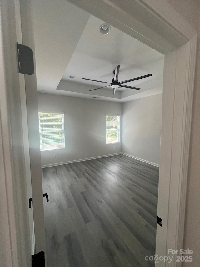 1312 W Monroe Rd, Salisbury, NC 28144 - spare room featuring baseboards, wood finished floors, a ceiling fan, and a raised ceiling