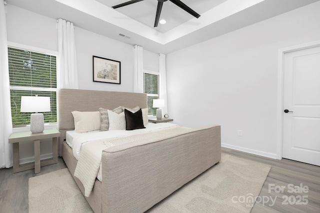 1312 W Monroe Rd, Salisbury, NC 28144 - bedroom featuring wood finished floors, recessed lighting, multiple windows, a ceiling fan, and a raised ceiling