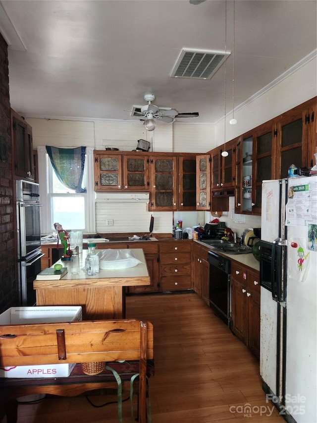 425 W Horah St, Salisbury, NC 28144 - kitchen featuring black appliances, wood finished floors, glass insert cabinets, dark countertops, and a sink
