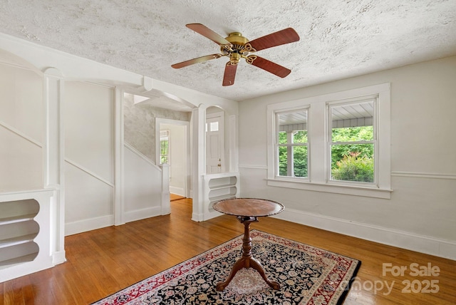 113 4th St, Black Mountain, NC 28711 - foyer entrance with wood finished floors, baseboards, a textured ceiling, and a ceiling fan