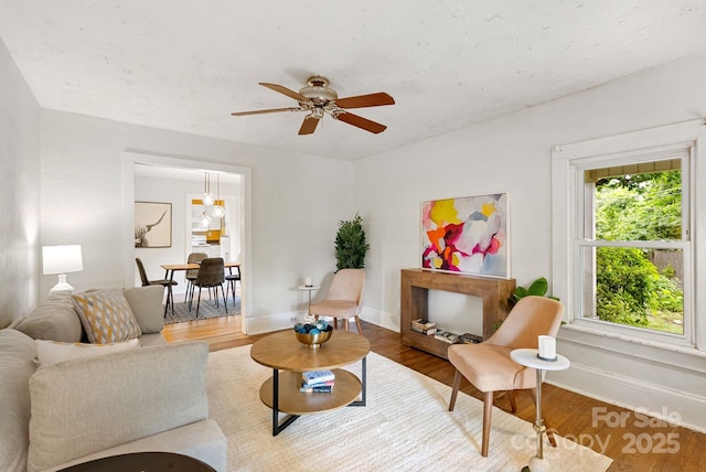113 4th St, Black Mountain, NC 28711 - living area with a ceiling fan, baseboards, and wood finished floors