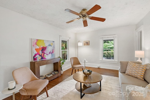 113 4th St, Black Mountain, NC 28711 - living area with wood finished floors, ceiling fan, baseboards, and a textured ceiling