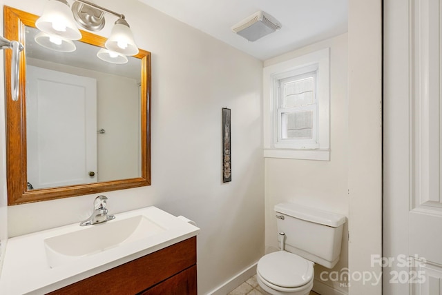 113 4th St, Black Mountain, NC 28711 - bathroom featuring vanity, toilet, and baseboards