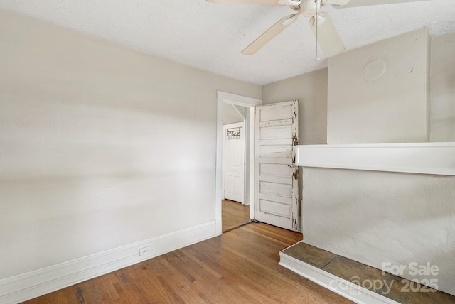 113 4th St, Black Mountain, NC 28711 - empty room with wood finished floors, a ceiling fan, and baseboards