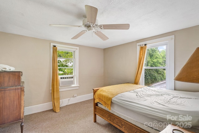113 4th St, Black Mountain, NC 28711 - bedroom with multiple windows, light carpet, cooling unit, ceiling fan, and a textured ceiling