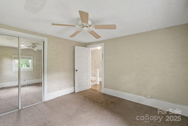 113 4th St, Black Mountain, NC 28711 - unfurnished bedroom with carpet flooring, a closet, a ceiling fan, baseboards, and a textured ceiling