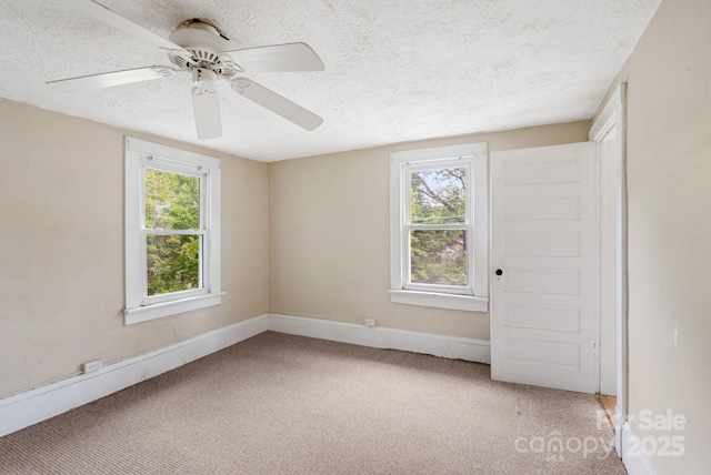 113 4th St, Black Mountain, NC 28711 - empty room with a textured ceiling, light carpet, healthy amount of natural light, ceiling fan, and baseboards