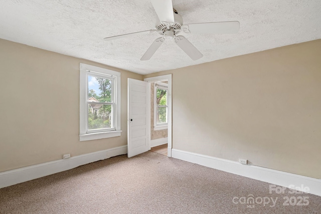 113 4th St, Black Mountain, NC 28711 - spare room featuring a textured ceiling, carpet floors, a ceiling fan, and baseboards