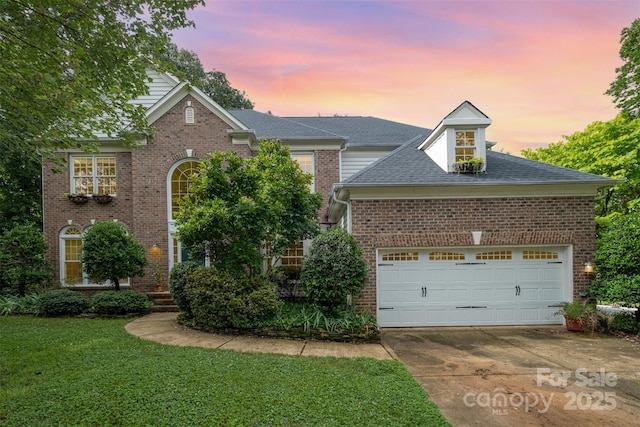 8219 Beardsley Dr, Charlotte, NC 28269 - traditional-style house with concrete driveway, a garage, a front yard, and brick siding