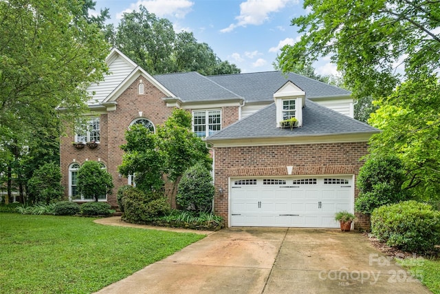 8219 Beardsley Dr, Charlotte, NC 28269 - traditional-style house with a front yard, roof with shingles, brick siding, and concrete driveway