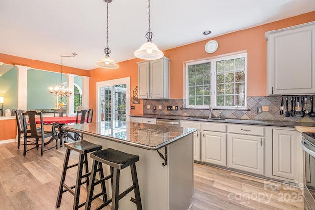 8219 Beardsley Dr, Charlotte, NC 28269 - kitchen with a sink, light wood finished floors, and tasteful backsplash