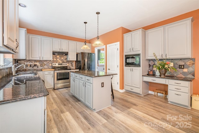 8219 Beardsley Dr, Charlotte, NC 28269 - kitchen featuring freestanding refrigerator, stainless steel range with electric stovetop, black microwave, a sink, and light wood-type flooring