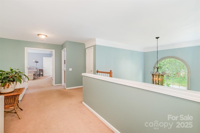 8219 Beardsley Dr, Charlotte, NC 28269 - corridor featuring light colored carpet, baseboards, and a chandelier