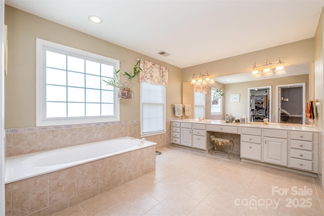 8219 Beardsley Dr, Charlotte, NC 28269 - full bath with vanity, healthy amount of natural light, a bath, tile patterned floors, and recessed lighting