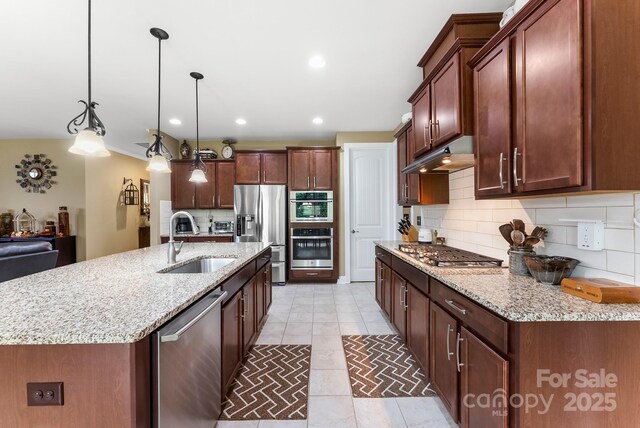 708 Ardent Trl, Belmont, NC 28012 - kitchen featuring a sink, stainless steel appliances, decorative backsplash, light stone counters, and under cabinet range hood
