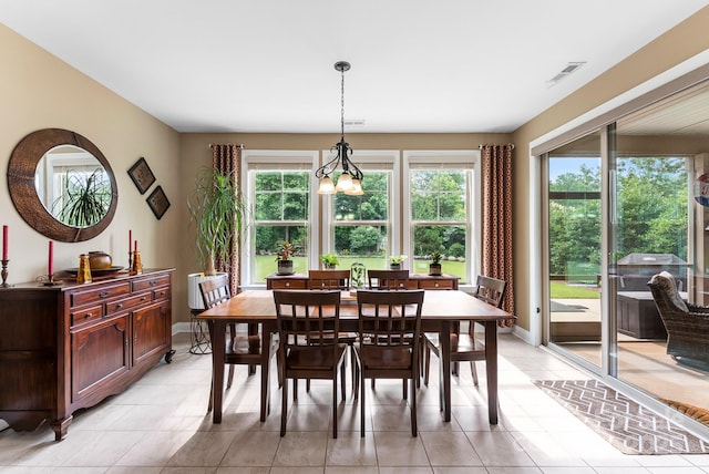 708 Ardent Trl, Belmont, NC 28012 - dining space with light tile patterned flooring, a chandelier, and baseboards