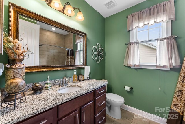 708 Ardent Trl, Belmont, NC 28012 - full bathroom with vanity, toilet, tiled shower, tile patterned flooring, and baseboards
