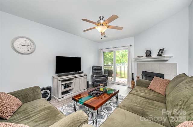 18741 Nautical Dr Unit 205, Cornelius, NC 28031 - living room featuring light wood-type flooring, ceiling fan, a fireplace, and baseboards