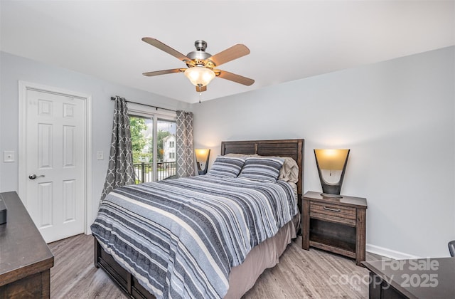 18741 Nautical Dr Unit 205, Cornelius, NC 28031 - bedroom with light wood finished floors, access to exterior, a ceiling fan, and baseboards