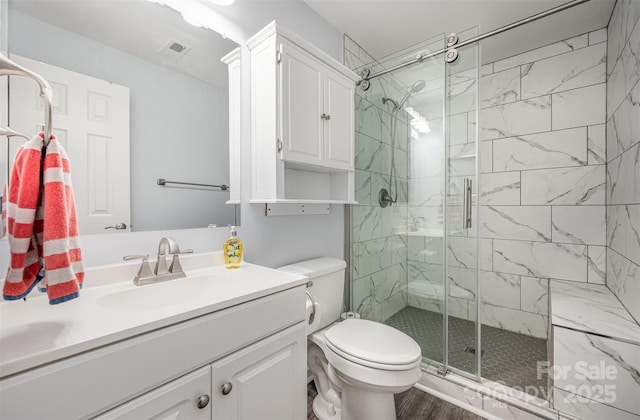 18741 Nautical Dr Unit 205, Cornelius, NC 28031 - full bathroom featuring vanity, a shower stall, toilet, and wood finished floors