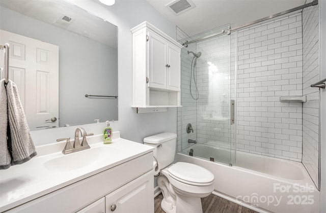 18741 Nautical Dr Unit 205, Cornelius, NC 28031 - bathroom featuring vanity, bath / shower combo with glass door, toilet, and wood finished floors